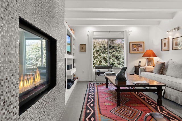tiled living area featuring beamed ceiling