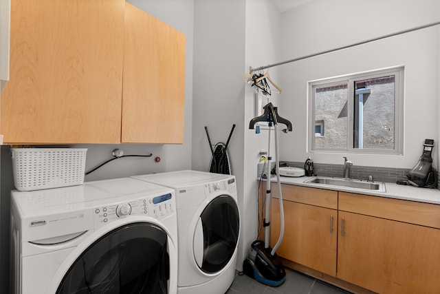 clothes washing area featuring washer and dryer, cabinet space, tile patterned flooring, and a sink