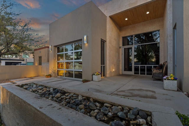 back of house with a patio, stucco siding, and fence