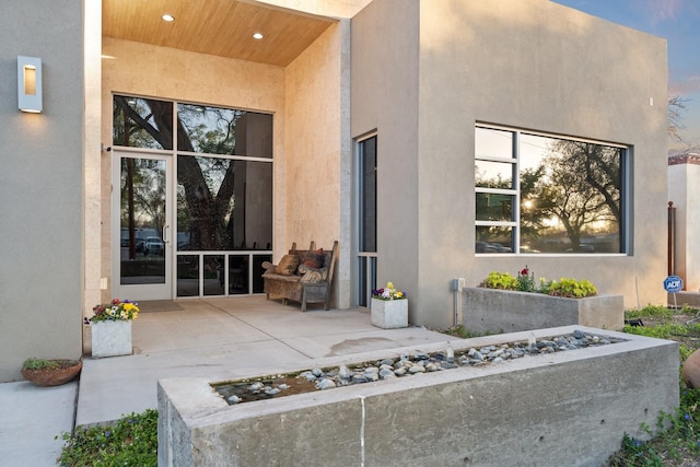 exterior space featuring a patio and stucco siding