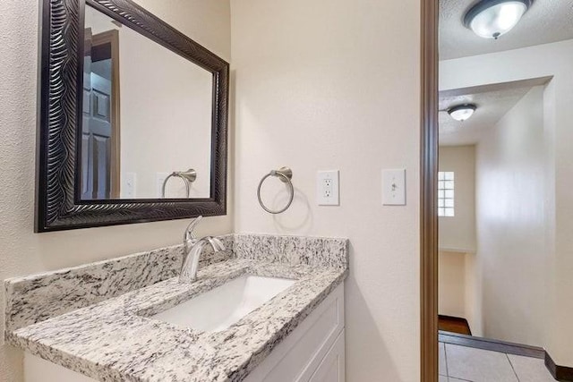 bathroom featuring tile patterned flooring and vanity