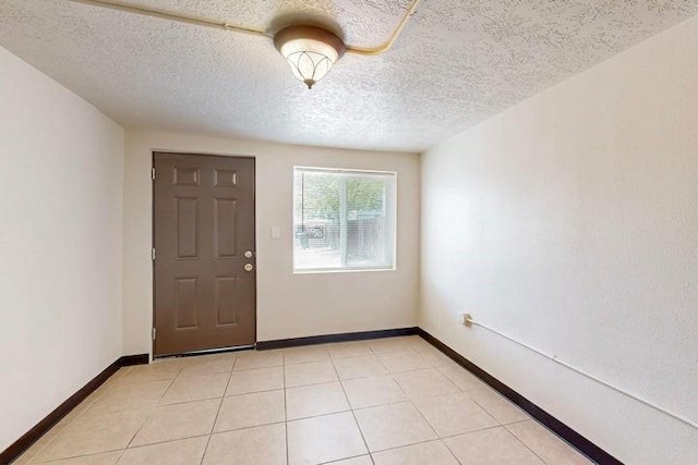 entryway with a textured ceiling and baseboards