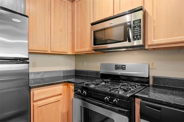 1405 Vegas Verdes Unit 341, Santa Fe, NM 87507 - kitchen featuring dark stone counters, light brown cabinetry, and appliances with stainless steel finishes