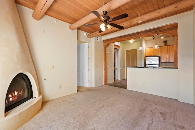 1405 Vegas Verdes Unit 341, Santa Fe, NM 87507 - unfurnished living room with wood ceiling, carpet, ceiling fan, a fireplace, and beam ceiling