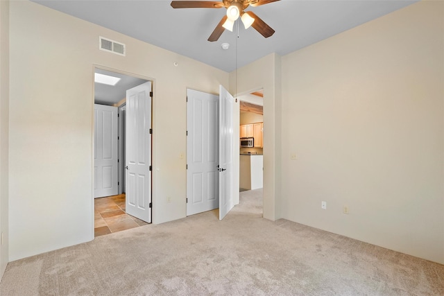 1405 Vegas Verdes Unit 341, Santa Fe, NM 87507 - unfurnished bedroom featuring light colored carpet, visible vents, and ceiling fan