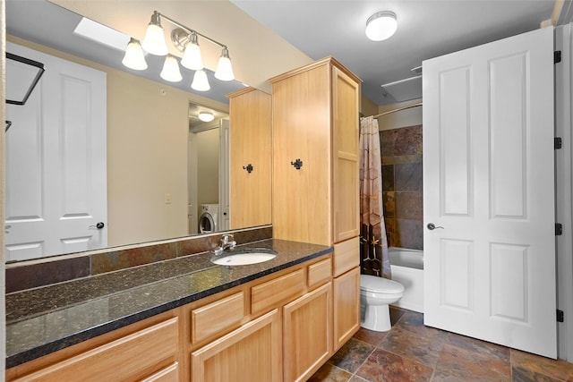 1405 Vegas Verdes Unit 341, Santa Fe, NM 87507 - full bath featuring stone finish flooring, washer and dryer, toilet, shower / bath combo with shower curtain, and vanity