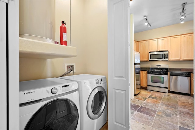 1405 Vegas Verdes Unit 341, Santa Fe, NM 87507 - laundry area featuring stone finish floor, washer and dryer, and laundry area