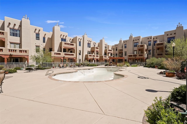 1405 Vegas Verdes Unit 341, Santa Fe, NM 87507 - surrounding community with a patio, a pool, fence, and a residential view