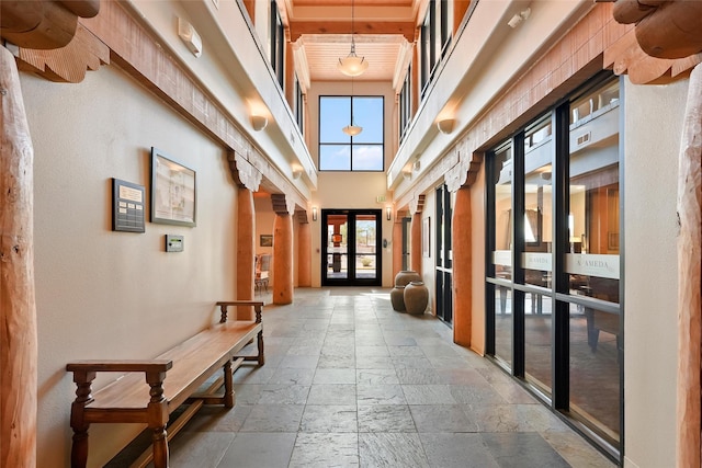 1405 Vegas Verdes Unit 341, Santa Fe, NM 87507 - interior space featuring stone tile floors, a towering ceiling, plenty of natural light, and baseboards