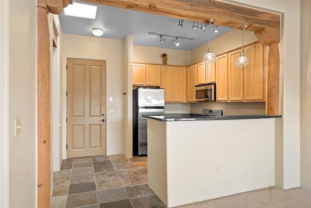 1405 Vegas Verdes Unit 341, Santa Fe, NM 87507 - kitchen with dark countertops, light brown cabinetry, a peninsula, and stainless steel appliances