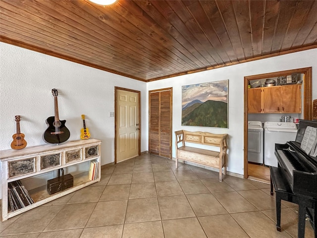 living area featuring wooden ceiling, ornamental molding, light tile patterned flooring, and washer and clothes dryer