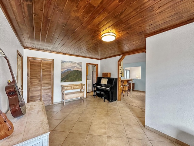 interior space featuring baseboards, wood ceiling, and light tile patterned flooring