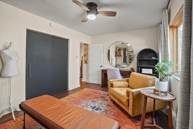 bedroom featuring baseboards, a ceiling fan, and wood finished floors