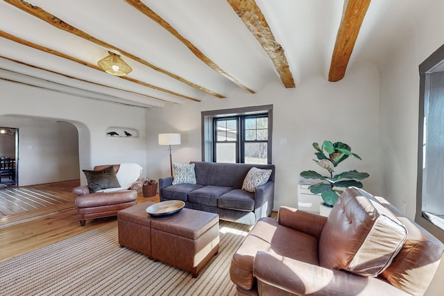 54 County Road B40A, Ribera, NM 87560 - living area featuring wood finished floors, arched walkways, and beamed ceiling