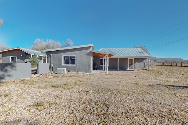 54 County Road B40A, Ribera, NM 87560 - back of property featuring stucco siding, metal roof, and cooling unit