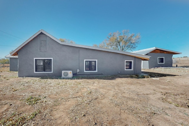 54 County Road B40A, Ribera, NM 87560 - rear view of house with a cooling unit and stucco siding