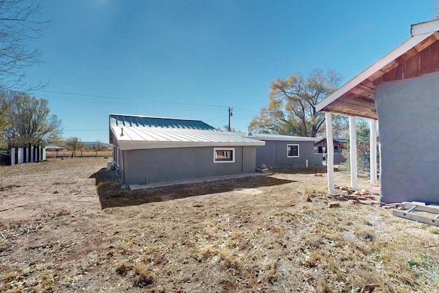54 County Road B40A, Ribera, NM 87560 - back of house with metal roof and a standing seam roof