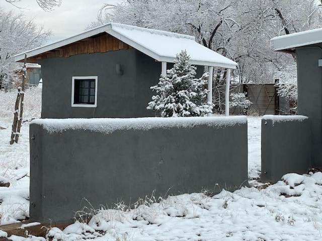 54 County Road B40A, Ribera, NM 87560 - snow covered property with stucco siding