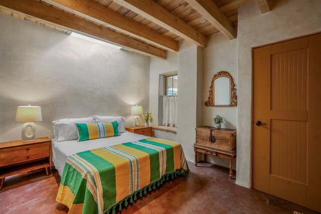 534 Hillside Ave, Santa Fe, NM 87501 - bedroom with finished concrete flooring, wooden ceiling, and beamed ceiling
