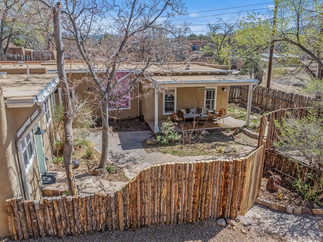534 Hillside Ave, Santa Fe, NM 87501 - back of house featuring a fenced backyard, an outdoor hangout area, stucco siding, and a patio