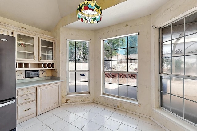 8228 Fairmont Dr NW, Albuquerque, NM 87120 - doorway featuring light tile patterned floors and vaulted ceiling