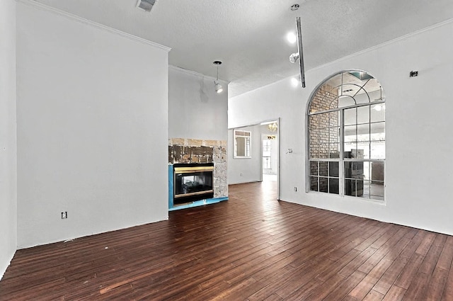 8228 Fairmont Dr NW, Albuquerque, NM 87120 - unfurnished living room with crown molding, a textured ceiling, a multi sided fireplace, visible vents, and hardwood / wood-style flooring