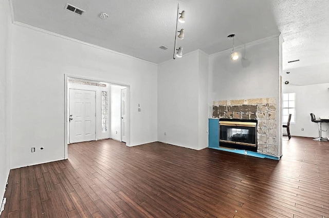 8228 Fairmont Dr NW, Albuquerque, NM 87120 - unfurnished living room featuring visible vents, a textured ceiling, crown molding, and wood finished floors