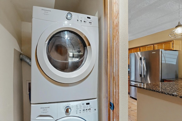 laundry area featuring laundry area and stacked washer and clothes dryer