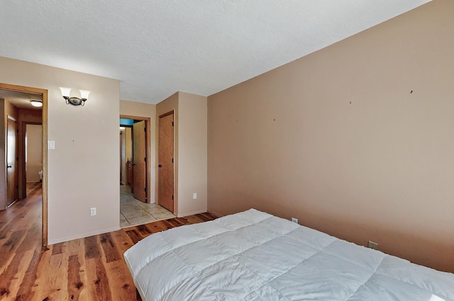 bedroom featuring baseboards and light wood-style floors