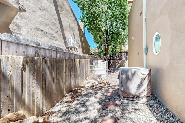 view of side of property featuring fence and stucco siding