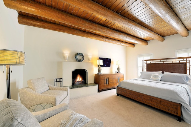 511 Armijo Unit C, Santa Fe, NM 87501 - bedroom featuring a warm lit fireplace, wooden ceiling, beam ceiling, and light carpet