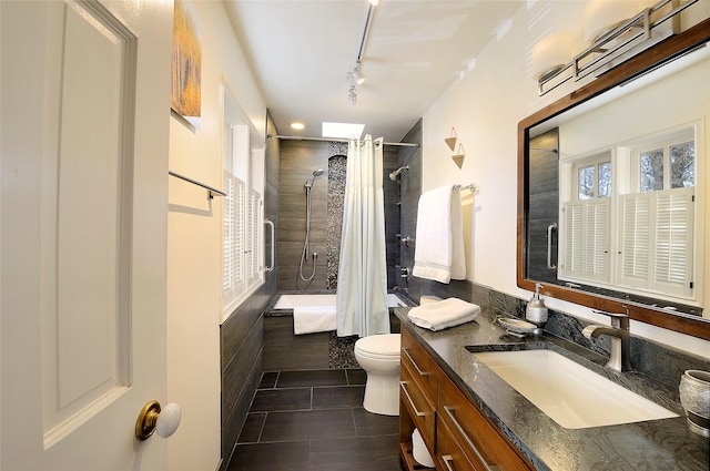 511 Armijo Unit C, Santa Fe, NM 87501 - full bath with tile patterned flooring, vanity, track lighting, toilet, and tiled shower / bath combo