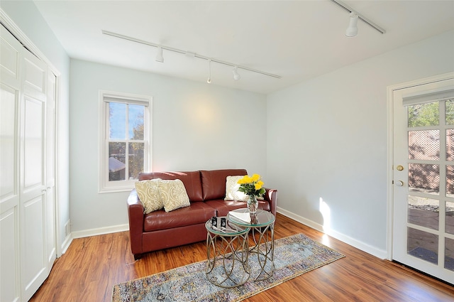 511 Armijo Unit C, Santa Fe, NM 87501 - living room with track lighting, baseboards, and wood finished floors