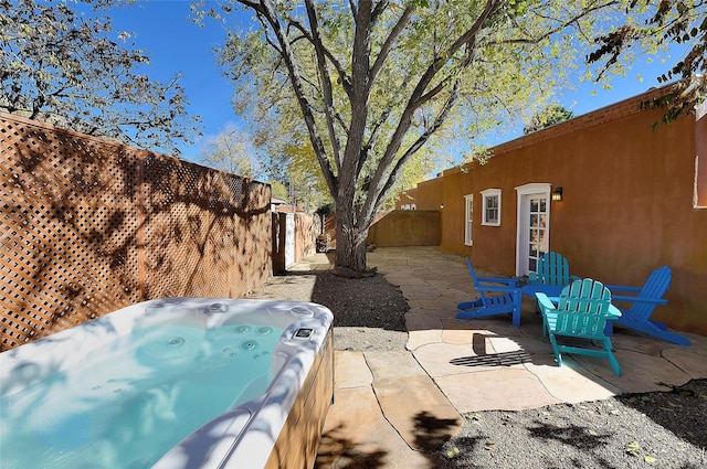 511 Armijo Unit C, Santa Fe, NM 87501 - view of patio / terrace with a fenced backyard and a hot tub
