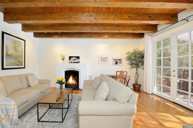 511 Armijo Unit C, Santa Fe, NM 87501 - living area featuring a fireplace with flush hearth, wood ceiling, light wood-style flooring, and beamed ceiling