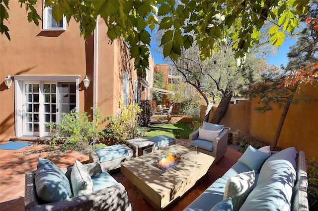 511 Armijo Unit C, Santa Fe, NM 87501 - view of patio with a fenced backyard and an outdoor living space with a fire pit