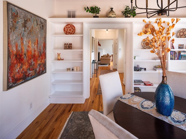 511 Armijo Unit C, Santa Fe, NM 87501 - office space featuring visible vents, baseboards, wood finished floors, and an inviting chandelier