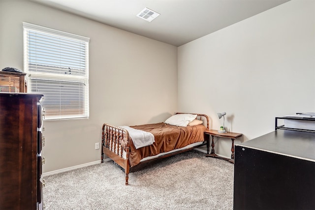 bedroom with baseboards, carpet, and visible vents