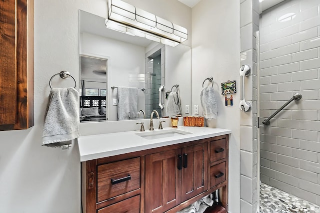 bathroom with vanity and a tile shower