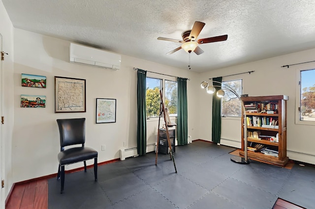 living area featuring a ceiling fan, a textured ceiling, a wall mounted AC, and a baseboard radiator