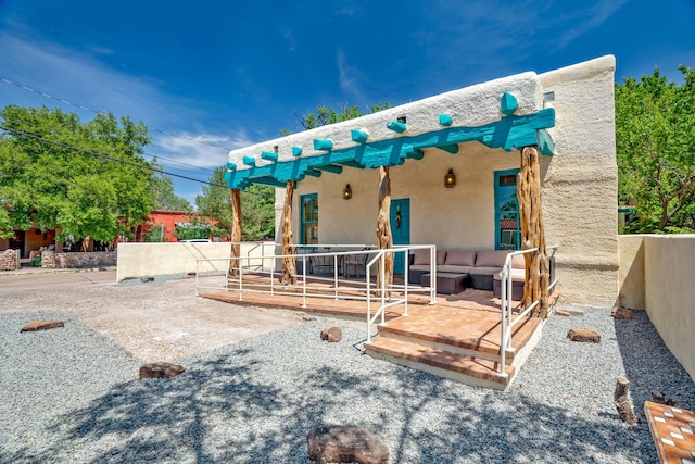 exterior space featuring a patio area, stucco siding, and an outdoor hangout area
