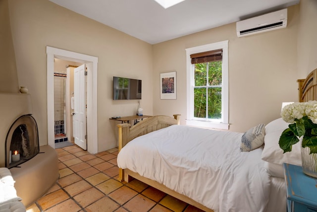 bedroom with a wall mounted AC and light tile patterned flooring