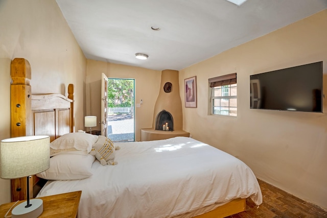 bedroom featuring access to outside and wood finished floors
