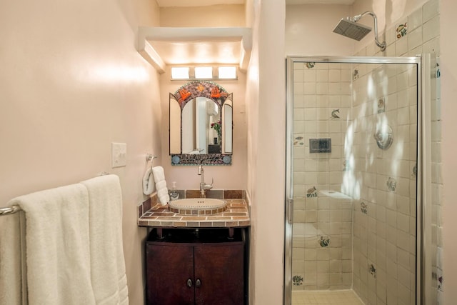 bathroom featuring a shower stall and vanity