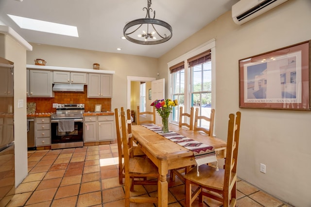 dining room featuring an inviting chandelier, a wall mounted air conditioner, recessed lighting, and a skylight