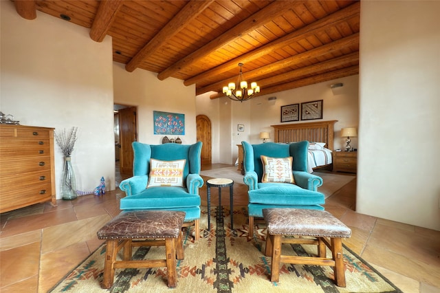 sitting room with stone tile flooring, a chandelier, wooden ceiling, and beamed ceiling