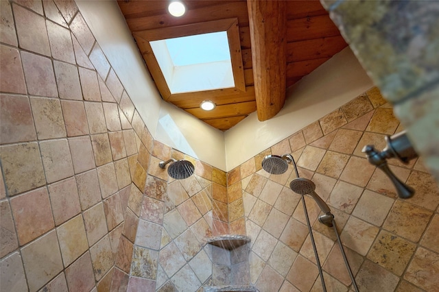 details with recessed lighting, a tile shower, and a skylight