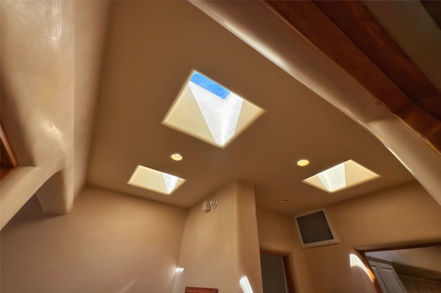 interior details with a skylight, recessed lighting, and visible vents