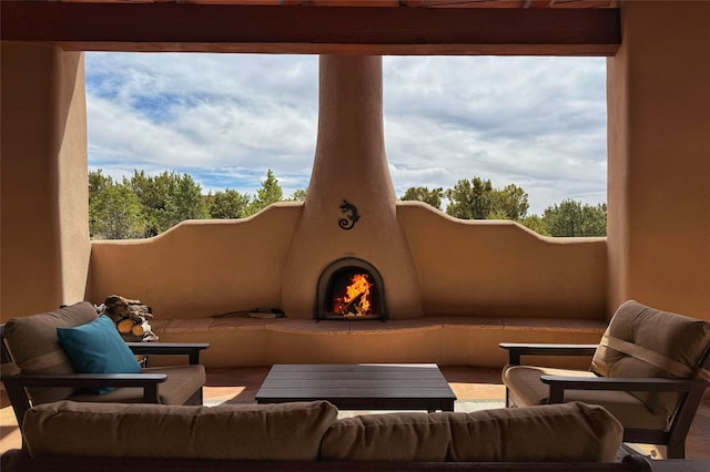 view of patio / terrace with an outdoor living space with a fireplace
