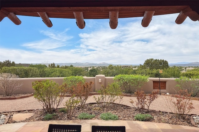 view of yard featuring fence and a mountain view